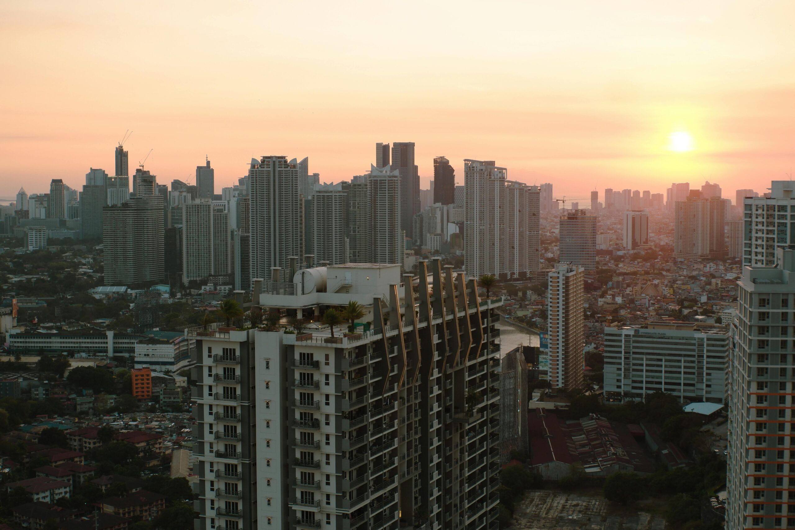 A breathtaking view of Taguig City skyline with skyscrapers at sunset.